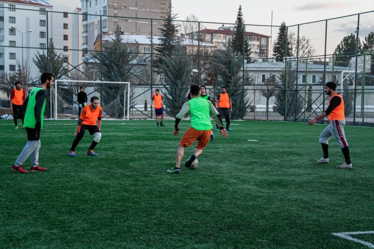 Casual soccer game on an outdoor field in İstanbul, Türkiye, showcasing teamwork and sportsmanship.